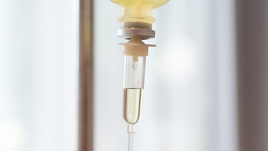 Close-up of an intravenous infusion drip chamber